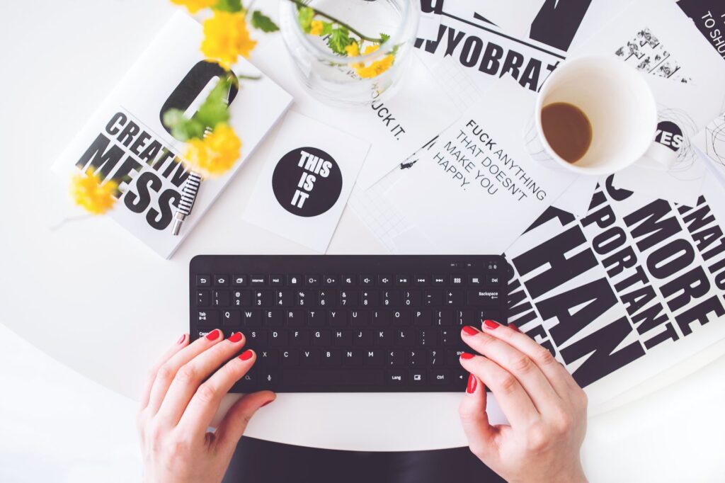 Writing Your First Blog Post? Stop Brainstorming And Do This Instead girl writing on a black keyboard