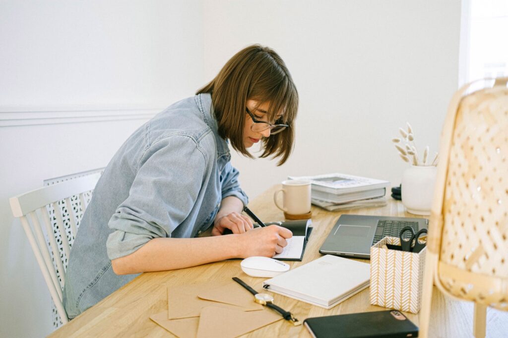 woman writing on a notebook