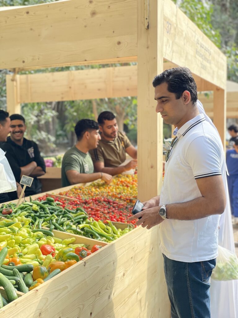 My husband choosing vegetables in a stall