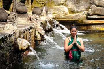 woman at the Tirta Empul Temple holy spring pool