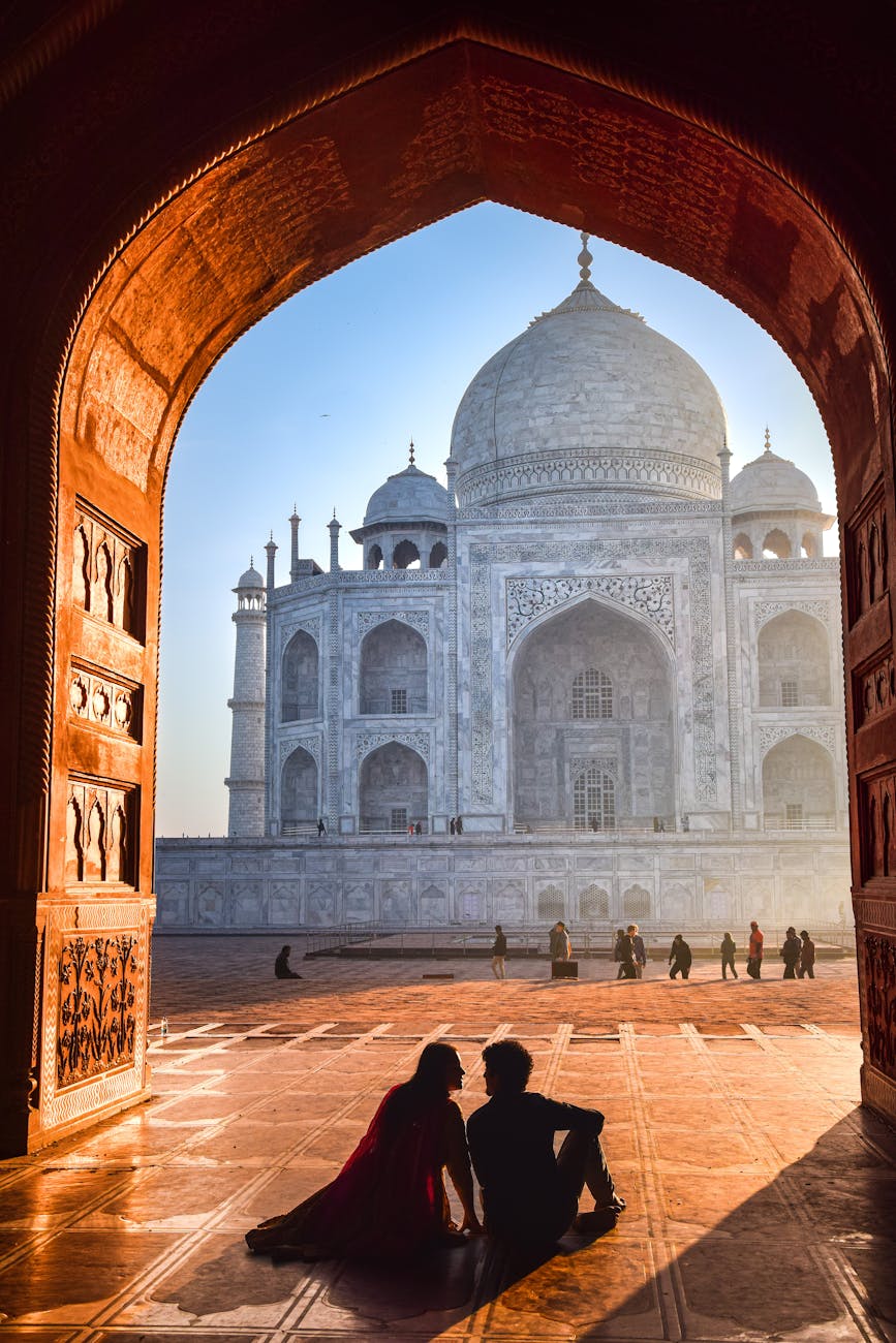 couple sitting at taj mahal