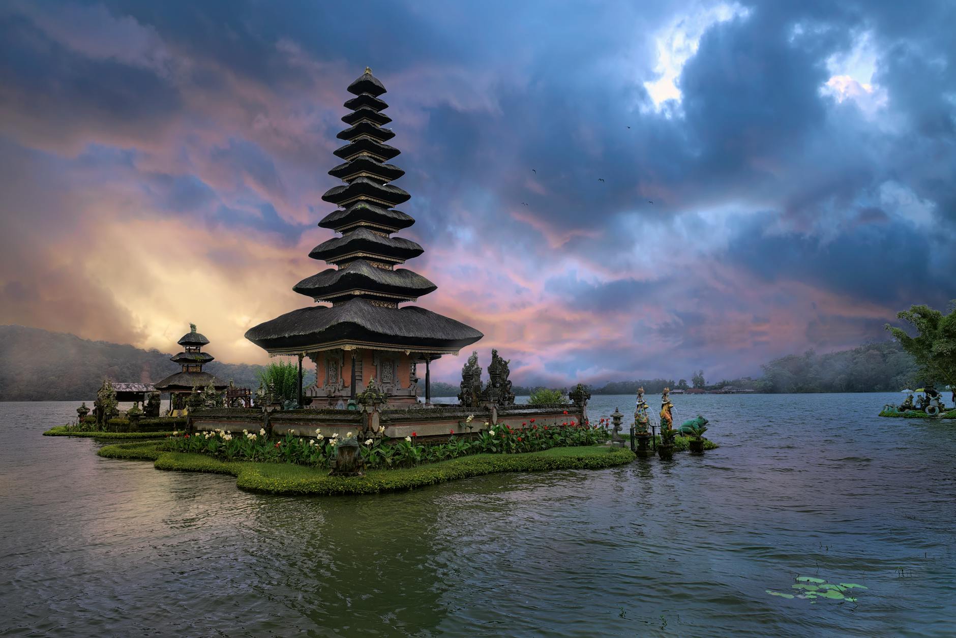brown and green temple near body of water under blue sky