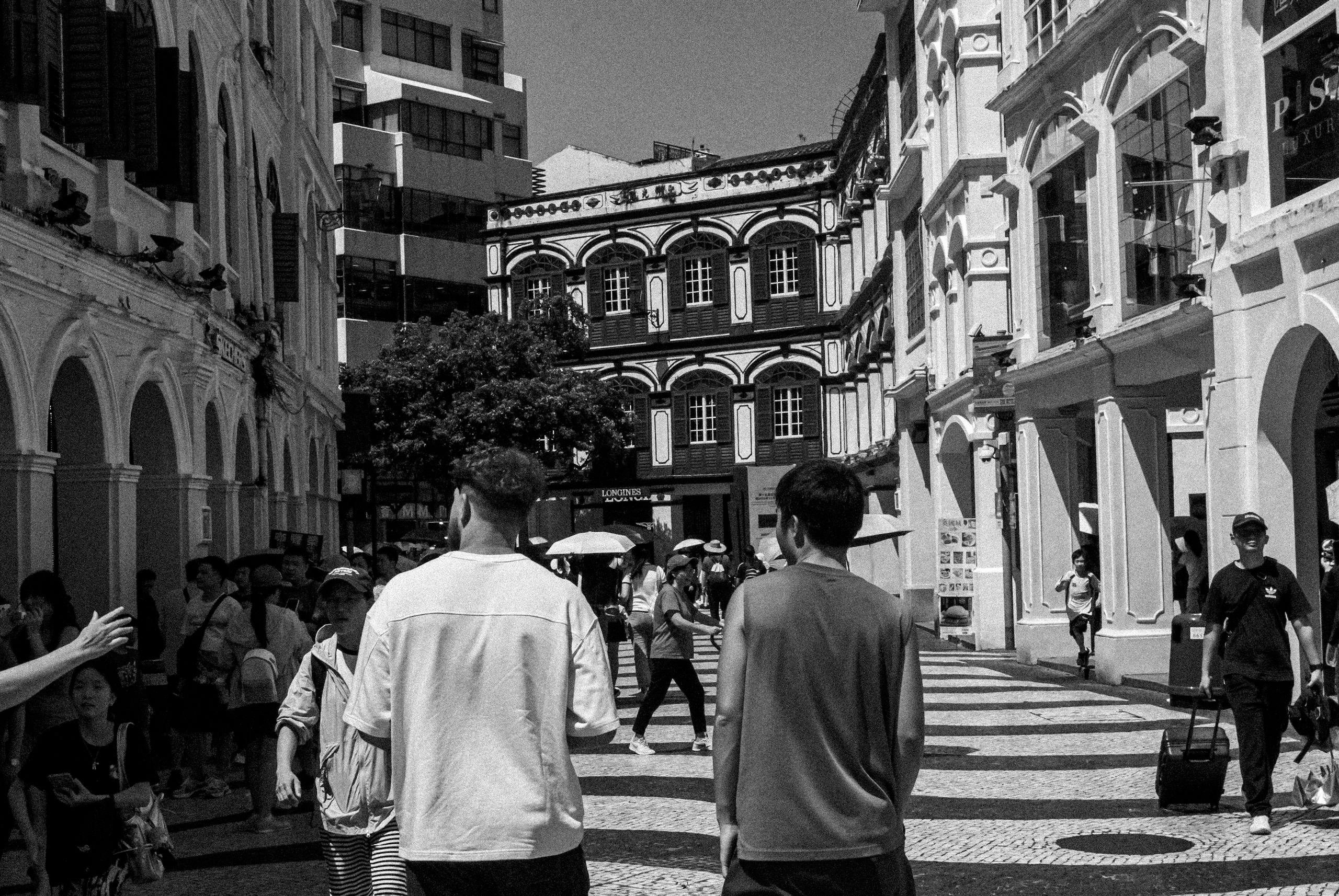 Crowded street with colonial architecture in the heart of Macau.